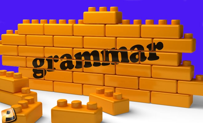 The word grammar printed across a wall of toy Lego-like blocks