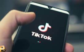 A smartphone being held displaying the Tiktok logo